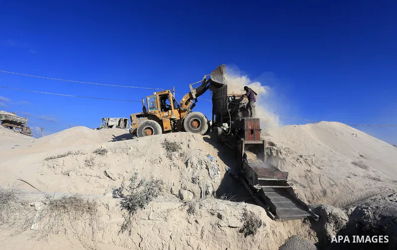 Palestinian workers smash large stones into small gravels to be used for building houses that witnesses said were destroyed by Israel during its offensive, in Gaza City September 14, 2014. An open-ended ceasefire between...
