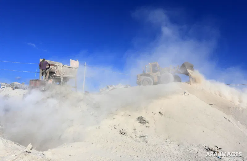 Palestinian workers smash large stones into small gravels to be used for building houses that witnesses said were destroyed by Israel during its offensive, in Gaza City September 14, 2014. An open-ended ceasefire between...