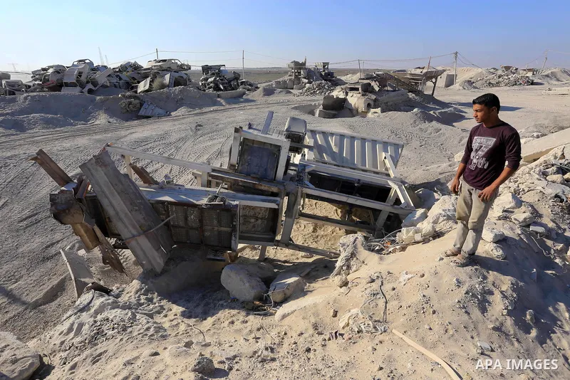 Palestinian workers smash large stones into small gravels to be used for building houses that witnesses said were destroyed by Israel during its offensive, in Gaza City September 14, 2014. An open-ended ceasefire between...
