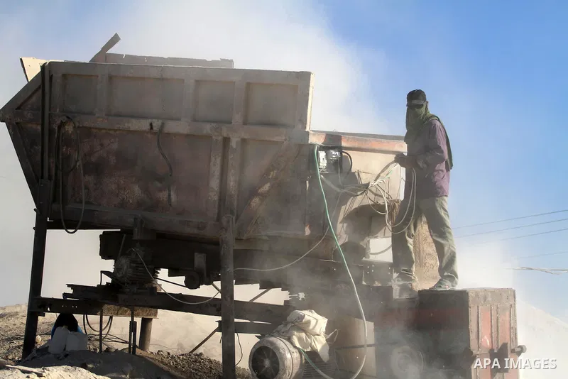 Palestinian workers smash large stones into small gravels to be used for building houses that witnesses said were destroyed by Israel during its offensive, in Gaza City September 14, 2014. An open-ended ceasefire between...