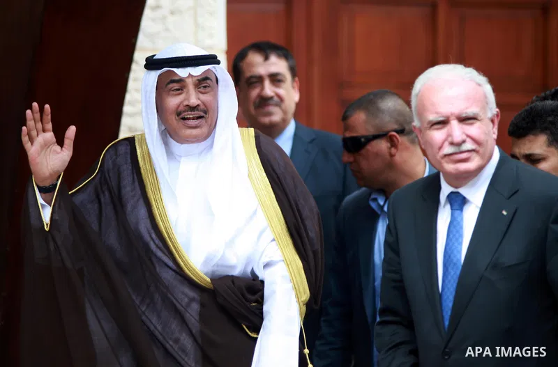 Kuwait's Minister of Foreign Affairs Sheikh Sabah al Khalid al Sabah waves upon arrival to meet Palestinian President Mahmoud Abbas (not pictured) in the West Bank city of Ramallah September 14, 2014. Photo by Shadi Hate...