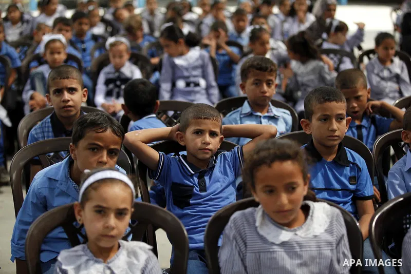 Palestinian students pose for a photograph during the visit of Pierre Krahenbuhl, United Nations Relief and Works Agency (UNRWA) Commissioner-Genera at a United Nations-run school on the first day of a new school year in...