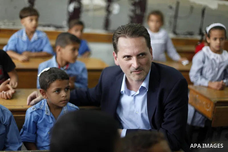 Pierre Krahenbuhl, United Nations Relief and Works Agency (UNRWA) Commissioner-General, sits with Palestinian students inside a classroom as he visits a United Nations-run school on the first day of a new school year in...