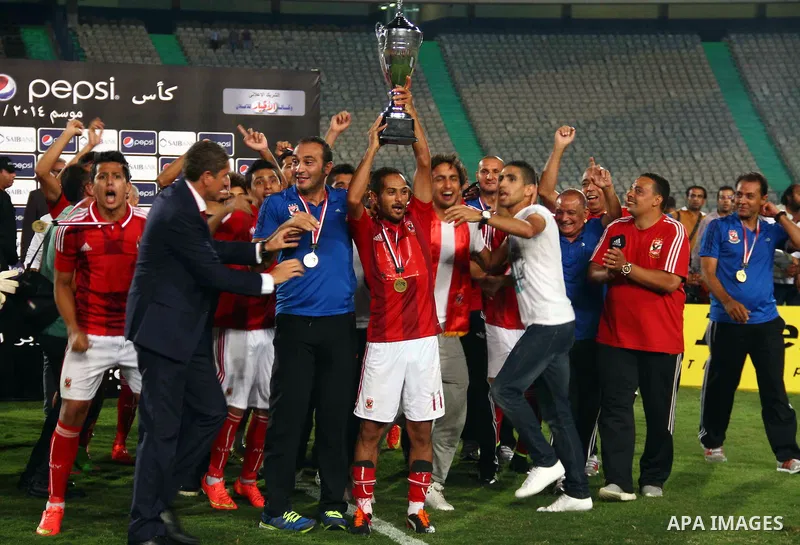 Al Ahly players celebrate with their trophy after winning their Egyptian Super Cup football match against Zamalek at the Cairo International Stadium, in Cairo, Egypt, Sunday Sept. 14, 2014. The Egyptian football associat...