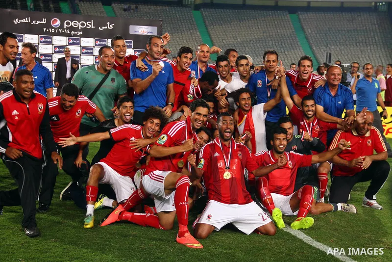 Al Ahly players celebrate with their trophy after winning their Egyptian Super Cup football match against Zamalek at the Cairo International Stadium, in Cairo, Egypt, Sunday Sept. 14, 2014. The Egyptian football associat...