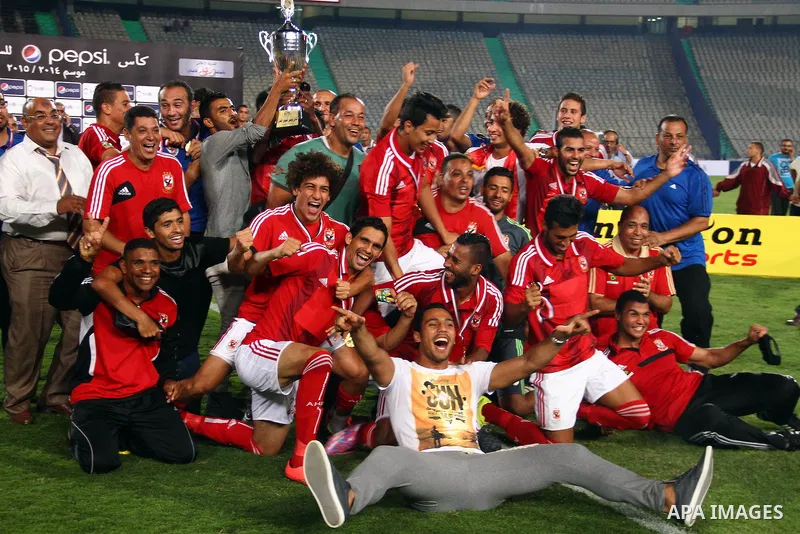 Al Ahly players celebrate with their trophy after winning their Egyptian Super Cup football match against Zamalek at the Cairo International Stadium, in Cairo, Egypt, Sunday Sept. 14, 2014. The Egyptian football associat...