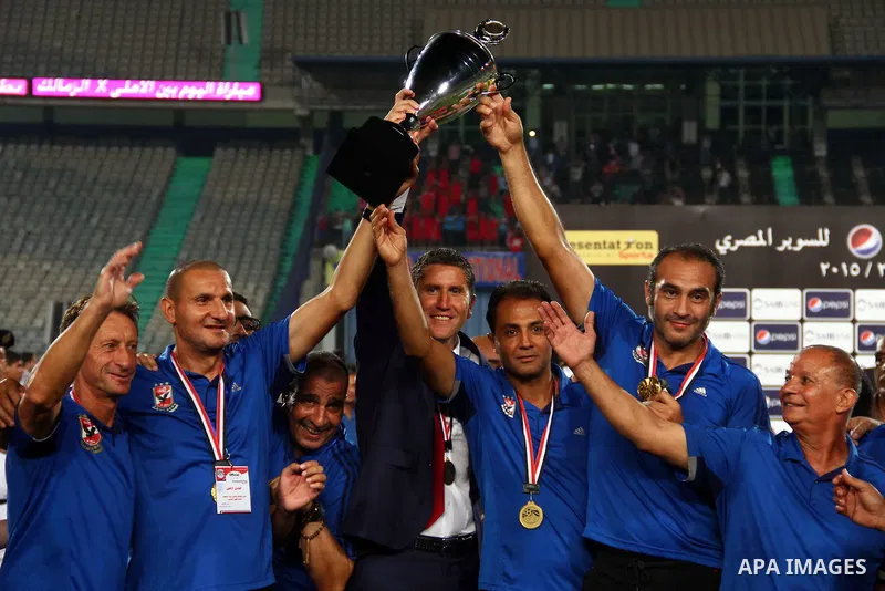 Al Ahly's technical staff and coach Juan Carlos Garrido celebrate with their trophy after winning their Egyptian Super Cup football match against Zamalek at the Cairo International Stadium, in Cairo, Egypt, Sunday Sept....