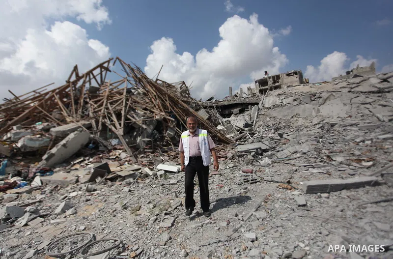 A Palestinian man stands on the rubbles of El-Wafa hospital, which witnesses said was destroyed during a seven-week Israeli offensive, in the east of Gaza City September 15, 2014. An open-ended ceasefire between Israel a...