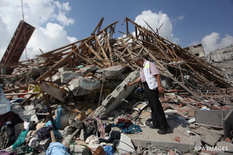 A Palestinian man stands on the rubbles of El-Wafa hospital, which witnesses said was destroyed during a seven-week Israeli offensive, in the east of Gaza City September 15, 2014. An open-ended ceasefire between Israel a...