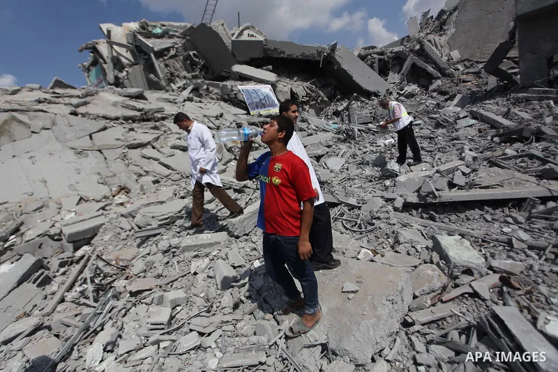 Palestinians stand on the rubbles of El-Wafa hospital, which witnesses said was destroyed during a seven-week Israeli offensive, in the east of Gaza City September 15, 2014. An open-ended ceasefire between Israel and Ham...
