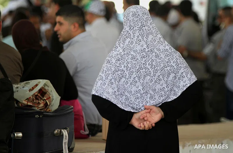 Palestinians Muslim pilgrims wait at Al-Karama crossing between the West Bank and Jordan near Jericho, on Sept. 16, 2014, before leaving for the annual hajj pilgrimage to the holy city of Mecca. Hundreds of Palestinian p...