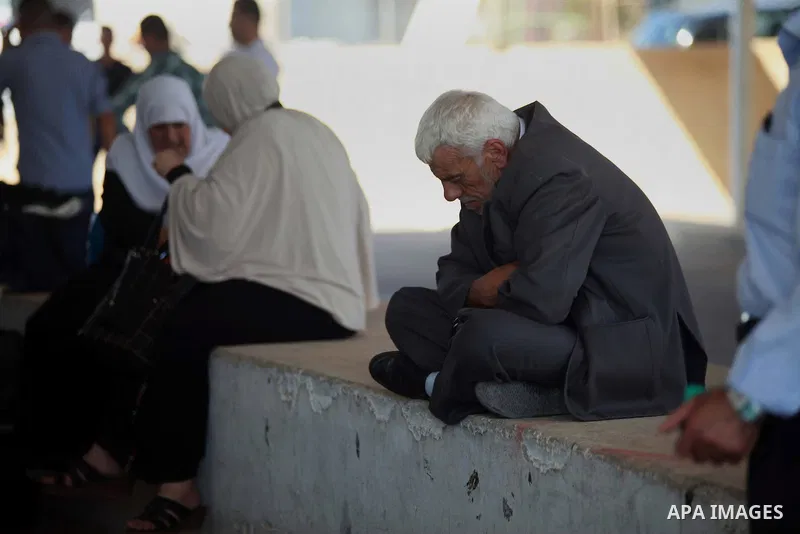 Palestinians Muslim pilgrims wait at Al-Karama crossing between the West Bank and Jordan near Jericho, on Sept. 16, 2014, before leaving for the annual hajj pilgrimage to the holy city of Mecca. Hundreds of Palestinian p...