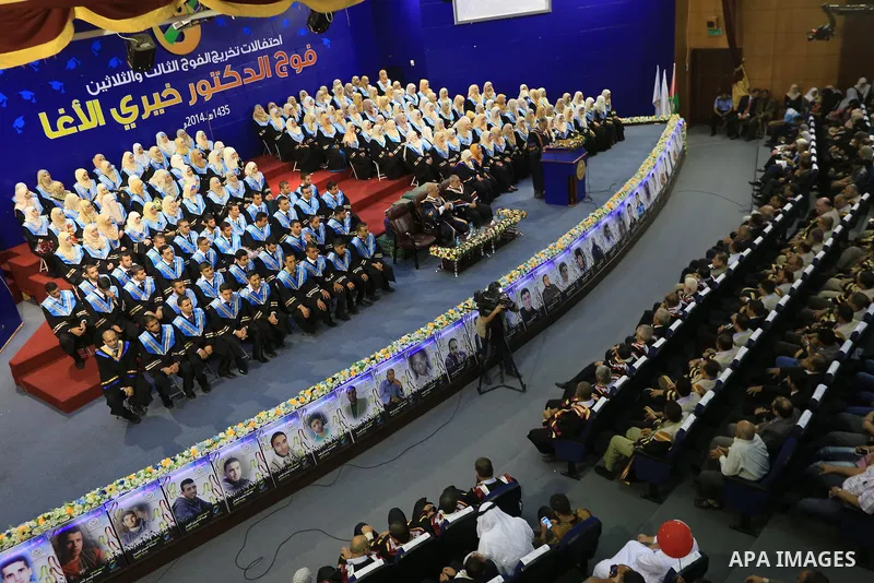 Palestinian students participate in their graduation ceremony at the Islamic University in Gaza city on September 16, 2014, supposed to be involved some of students were killed during air raids on the Gaza Strip. Photo b...