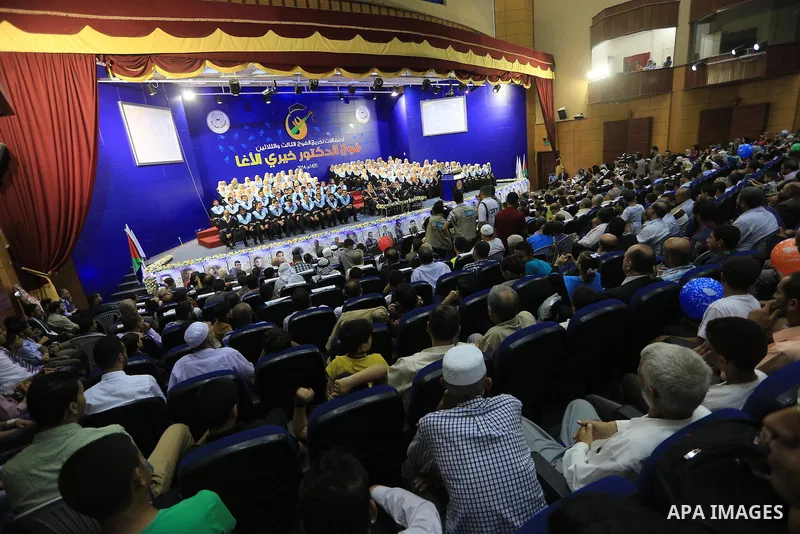 Palestinian students participate in their graduation ceremony at the Islamic University in Gaza city on September 16, 2014, supposed to be involved some of students were killed during air raids on the Gaza Strip. Photo b...