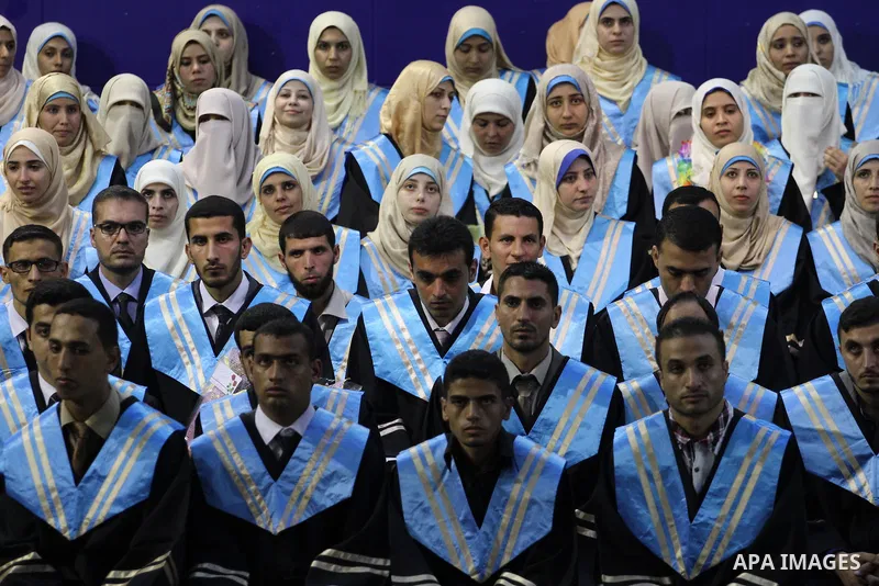 Palestinian students participate in their graduation ceremony at the Islamic University in Gaza city on September 16, 2014, supposed to be involved some of students were killed during air raids on the Gaza Strip. Photo b...