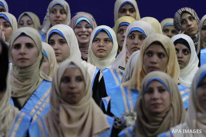 Palestinian students participate in their graduation ceremony at the Islamic University in Gaza city on September 16, 2014, supposed to be involved some of students were killed during air raids on the Gaza Strip. Photo b...