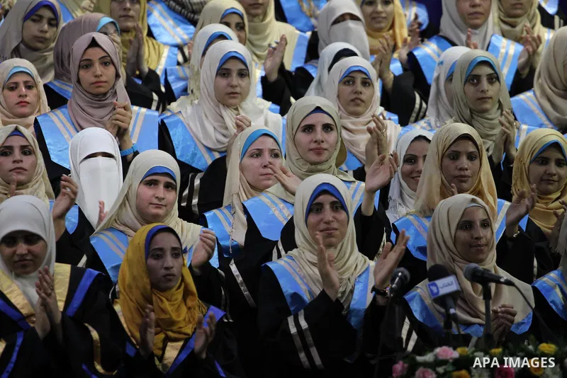 Palestinian students participate in their graduation ceremony at the Islamic University in Gaza city on September 16, 2014, supposed to be involved some of students were killed during air raids on the Gaza Strip. Photo b...