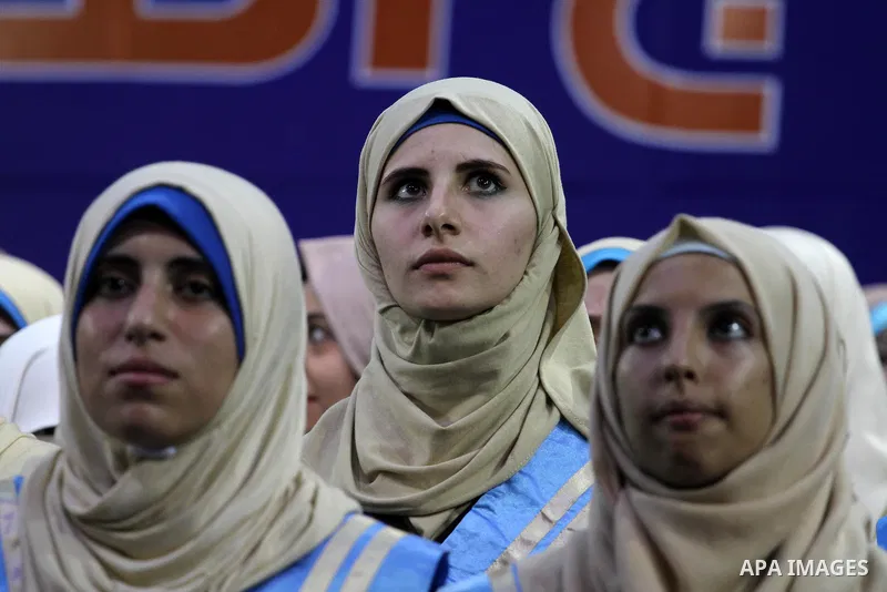 Palestinian students participate in their graduation ceremony at the Islamic University in Gaza city on September 16, 2014, supposed to be involved some of students were killed during air raids on the Gaza Strip. Photo b...