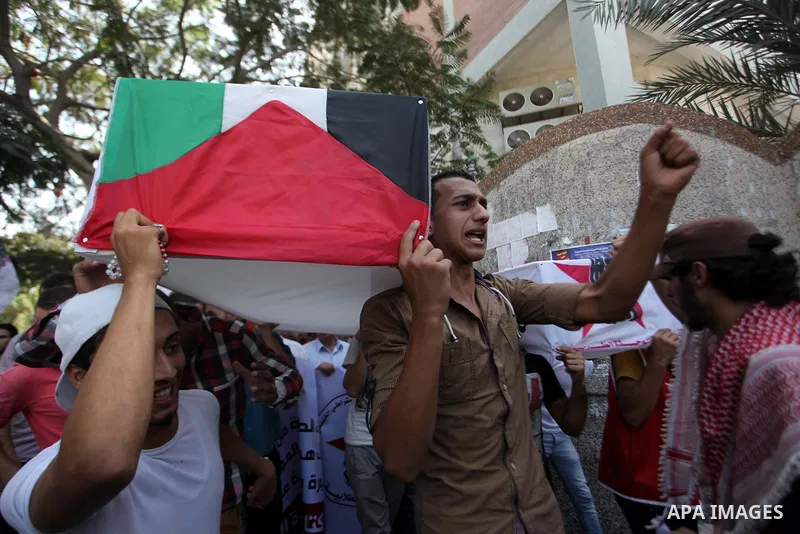 Palestinian University students take part in a protest to demand for exemption from tuition fees, in Gaza city, on Sept. 17, 2014. An open-ended ceasefire between Israel and Hamas-led Gaza militants, mediated by Egypt, t...
