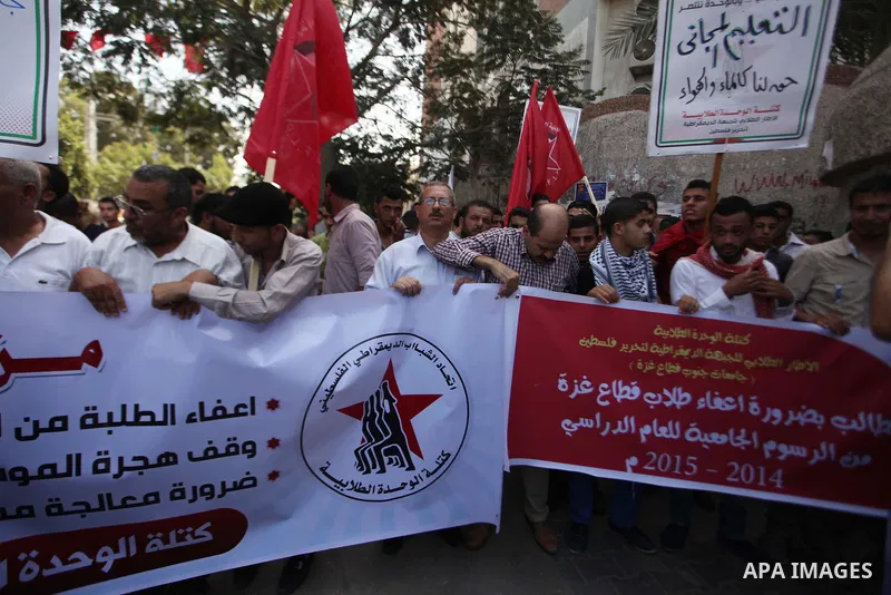 Palestinian University students take part in a protest to demand for exemption from tuition fees, in Gaza city, on Sept. 17, 2014. An open-ended ceasefire between Israel and Hamas-led Gaza militants, mediated by Egypt, t...