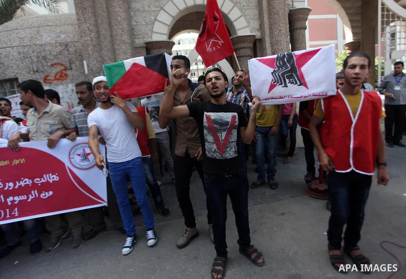 Palestinian University students take part in a protest to demand for exemption from tuition fees, in Gaza city, on Sept. 17, 2014. An open-ended ceasefire between Israel and Hamas-led Gaza militants, mediated by Egypt, t...