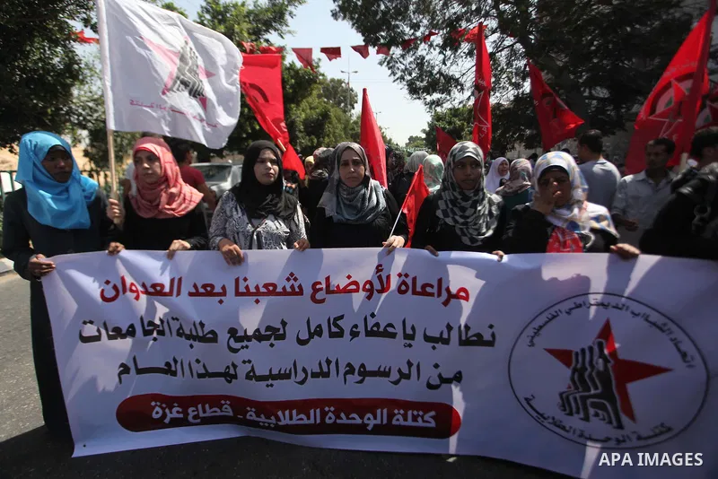 Palestinian University students take part in a protest to demand for exemption from tuition fees, in Gaza city, on Sept. 17, 2014. An open-ended ceasefire between Israel and Hamas-led Gaza militants, mediated by Egypt, t...