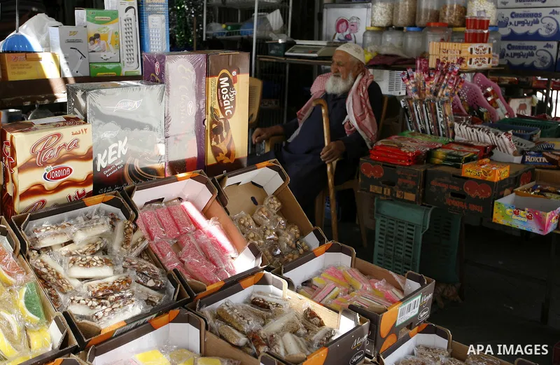 A Palestinian shopkeeper works in his shop at a market in Rafah in the southern Gaza Strip on Sept. 17, 2014. An open-ended ceasefire between Israel and Hamas-led Gaza militants, mediated by Egypt, took effect on August...
