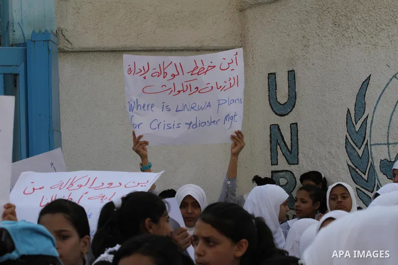 Palestinian Students hold banners during a protest to get out displaced from their schools in front of the headquarters of UNRWA in Gaza City September 18, 2014. An open-ended ceasefire between Israel and Hamas-led Gaza...
