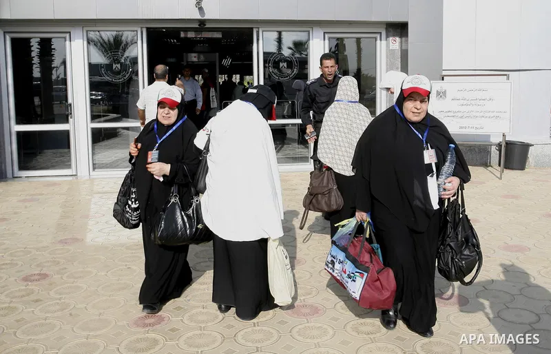 Palestinians Muslim pilgrims wait at the Rafah crossing between Egypt and the southern Gaza Strip, on Sept. 18, 2014, before leaving for the annual hajj pilgrimage to the holy city of Mecca. Hundreds of Palestinian pilgr...