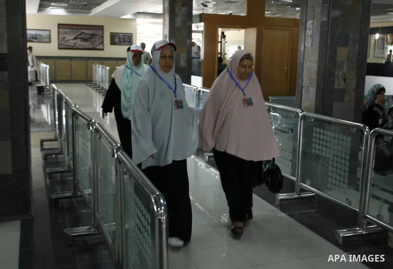 Palestinians Muslim pilgrims wait at the Rafah crossing between Egypt and the southern Gaza Strip, on Sept. 18, 2014, before leaving for the annual hajj pilgrimage to the holy city of Mecca. Hundreds of Palestinian pilgr...