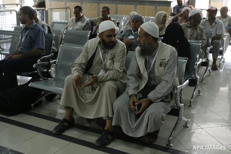 Palestinians Muslim pilgrims wait at the Rafah crossing between Egypt and the southern Gaza Strip, on Sept. 18, 2014, before leaving for the annual hajj pilgrimage to the holy city of Mecca. Hundreds of Palestinian pilgr...