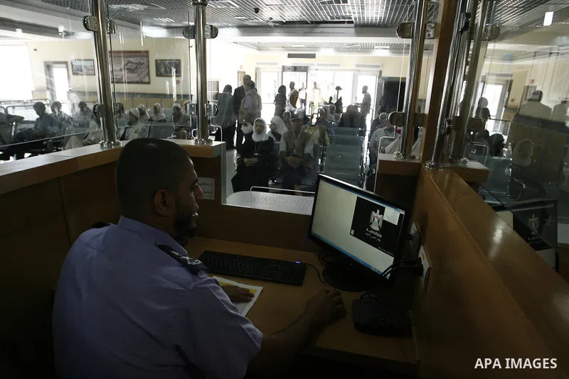 Palestinians Muslim pilgrims wait at the Rafah crossing between Egypt and the southern Gaza Strip, on Sept. 18, 2014, before leaving for the annual hajj pilgrimage to the holy city of Mecca. Hundreds of Palestinian pilgr...