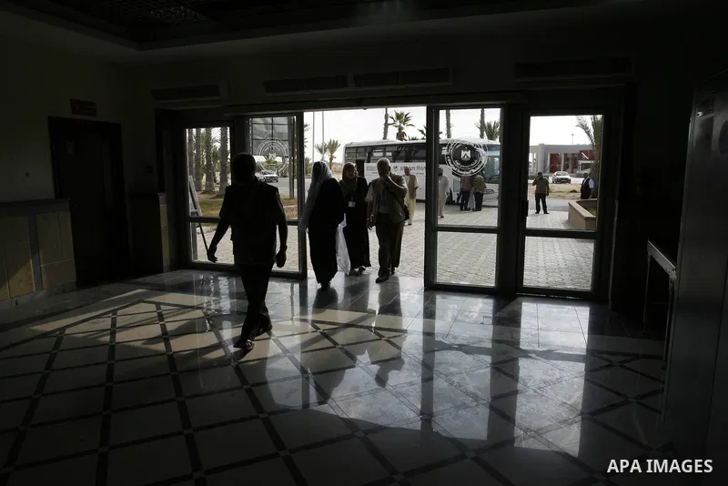 Palestinians Muslim pilgrims wait at the Rafah crossing between Egypt and the southern Gaza Strip, on Sept. 18, 2014, before leaving for the annual hajj pilgrimage to the holy city of Mecca. Hundreds of Palestinian pilgr...