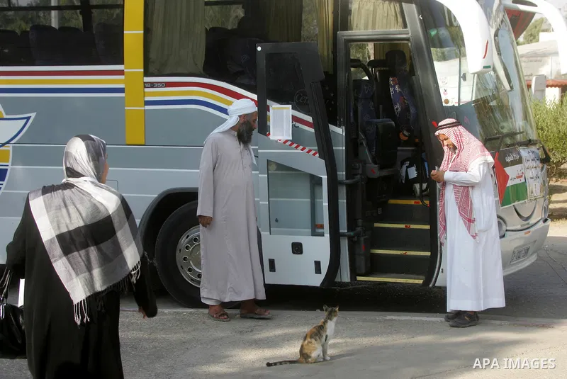 Palestinians Muslim pilgrims wait at the Rafah crossing between Egypt and the southern Gaza Strip, on Sept. 18, 2014, before leaving for the annual hajj pilgrimage to the holy city of Mecca. Hundreds of Palestinian pilgr...