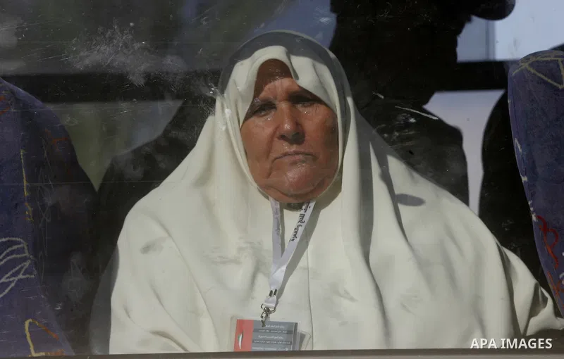 Palestinians Muslim pilgrims wave as they sit in a bus before leaving the Rafah border crossing between Egypt and the southern Gaza Strip, on Sept. 18, 2014, before leaving for the annual hajj pilgrimage to the holy city...