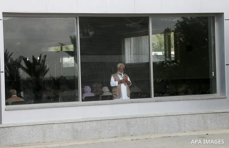 Palestinians Muslim pilgrims wait at the Rafah crossing between Egypt and the southern Gaza Strip, on Sept. 18, 2014, before leaving for the annual hajj pilgrimage to the holy city of Mecca. Hundreds of Palestinian pilgr...
