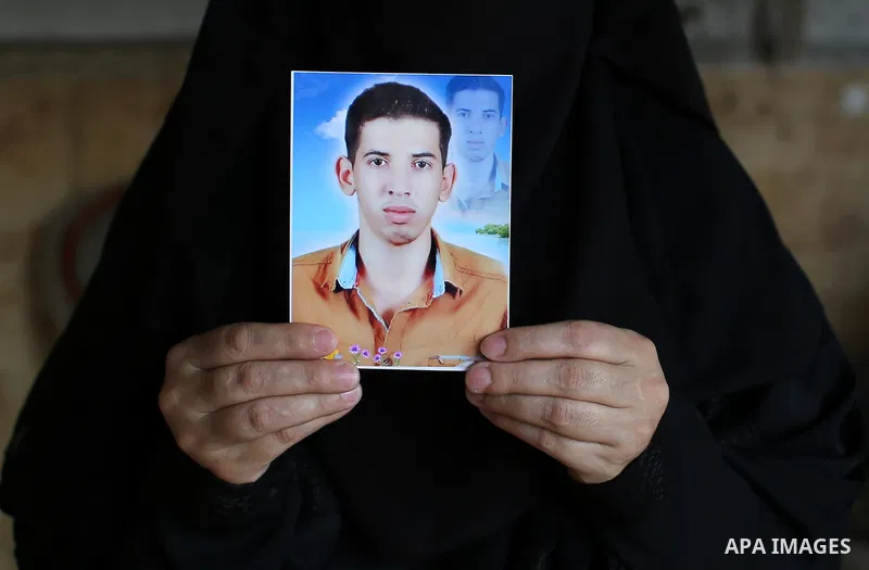 Palestinian Soad al-Jorf, 36, holds a picture of her son Hussein al-Jorf, 19, in her house which was hit by Israeli shelling during the war, in Khan Yunis town in the southern Gaza Strip, on September 18, 2014. Hussein a...