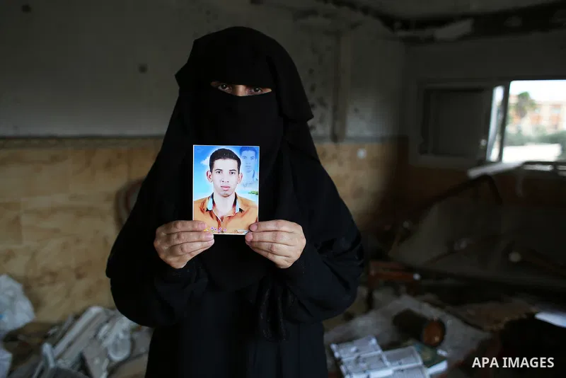 Palestinian Soad al-Jorf, 36, holds a picture of her son Hussein al-Jorf, 19, in her house which was hit by Israeli shelling during the war, in Khan Yunis town in the southern Gaza Strip, on September 18, 2014. Hussein a...