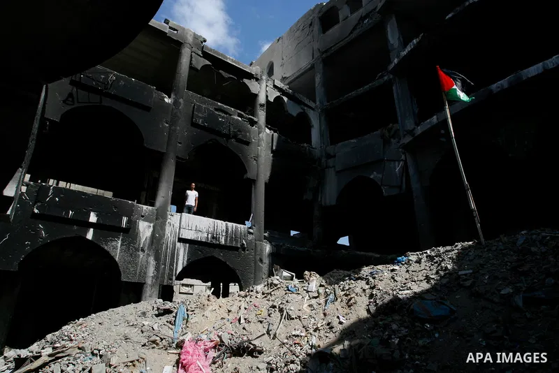 A Palestinian man stand in the heavily damaged commercial center which was destroyed by Israeli strikes during the summer's fierce offensive, in Rafah in the southern Gaza Strip September 23, 2014. Gazans who endured mor...