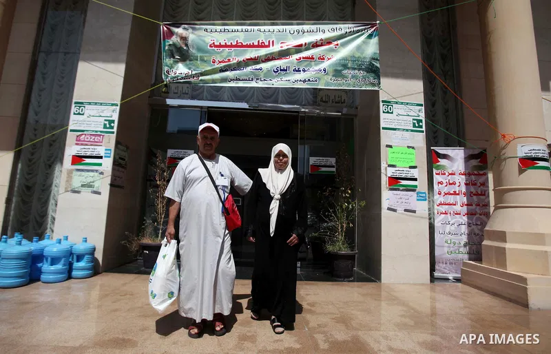 Muslim pilgrims walk outside the center of Palestinian medical delegation following receive treatment, in mecca, Saudi Arabia, September 23, 2014. The Hajj is one of the world's biggest displays of mass religious devotio...