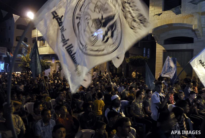 Palestinian Hamas supporters take part in a demonstration against the killing of Marwan Kawasme and Amar Abu Aysha Israeli troops, in Jabalia in the northern Gaza Strip, September 23, 2014. Israeli troops shot dead two P...