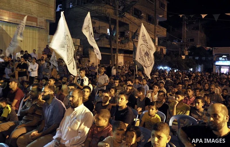 Palestinian Hamas supporters take part in a demonstration against the killing of Marwan Kawasme and Amar Abu Aysha Israeli troops, in Jabalia in the northern Gaza Strip, September 23, 2014. Israeli troops shot dead two P...