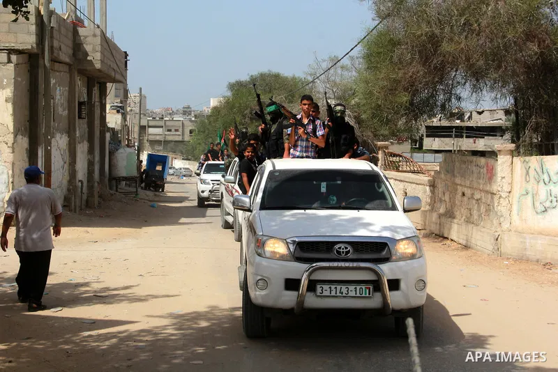 Palestinian Hamas militants stand guard as others celebrate the release of Palestinian Salim al-Hashash from an Israeli jail, in Rafah in the southern Gaza Strip September 24 , 2014. Al-Hashash served 10 years in the Isr...