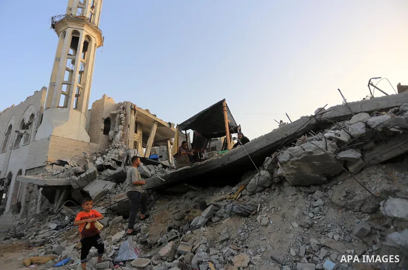 Palestinians sit in a tent near the rubble of the damaged house which was destroyed by Israeli strikes during the summer's fierce offensive, at Shejaiya neighborhood in the east of Gaza city, Sep. 24, 2014. Head of the P...