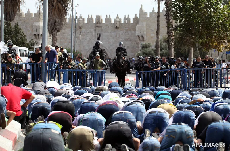 Palestinian Muslims pray outside of the Old City of Jerusalem as Israeli police block them from praying in the city's Al-Aqsa mosque, in the Ras Al-Amud neighborhood of East Jerusalem on Spe. 26, 2014. Israeli police ste...