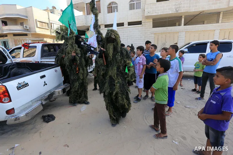 Members of Ezzedin al-Qassam brigades take part in a ceremony to honor Palestinians who were killed by Israel during the summer's fierce offensive, in Gaza city on Sep. 26, 2014. Palestinian leader Mahmoud Abbas returned...