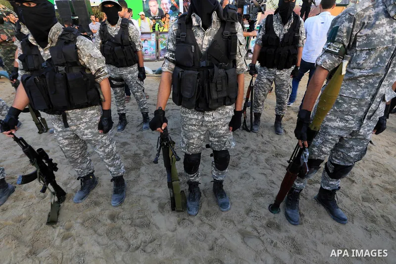 Members of Ezzedin al-Qassam brigades take part in a ceremony to honor Palestinians who were killed by Israel during the summer's fierce offensive, in Gaza city on Sep. 26, 2014. Palestinian leader Mahmoud Abbas returned...