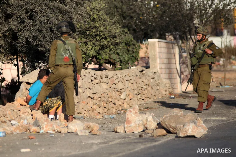 Israeli security forces detain a Palestinian youth uring clashes with Palestinian protesters at a protest against the Jewish settlement of Ofra, in the West Bank village of Silwad, near Ramallah September 26, 2014. Pales...