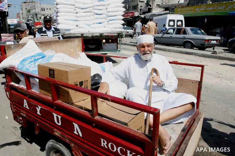 A Palestinian man receives food supplies from a distribution centre of the United Nations Relief and Works Agency (UNRWA) in Rafah in southern Gaza strip on Sept. 28, 2014. The aid was sent to the U.N. office to be distr...