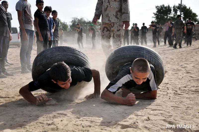 Young Palestinians take part in a military-style exercise at a training course organized by Hamas movement in Gaza City Spe. 28, 2014. Reports said that Hamas planning to establish a 'popular army' in Gaza to help in nex...